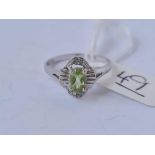 A white gold and peridot ring 10ct gold size N1/2