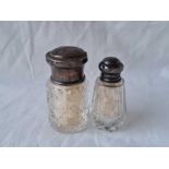Two silver mounted salts bottles with glass bodies - one London 1904