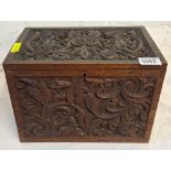 A late Victorian oak box carved with scrolls etc. - 10" wide