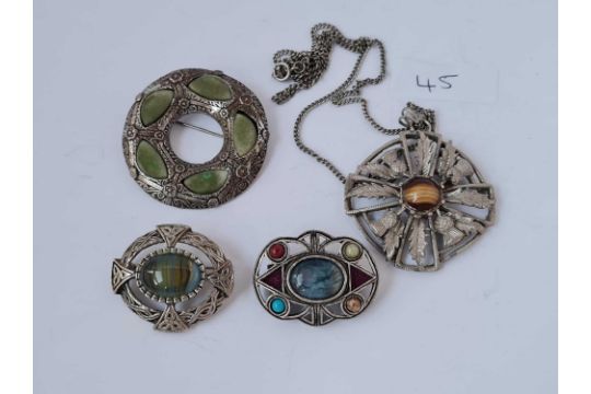 Four metal Scottish type brooches and necklace