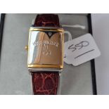 A boxed HUGO BUCHESER metal cased slide over wrist watch with leather strap (as new)