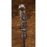A Trobriand Islands Lime-Spatula carved from wood depicting a squatting figure to the handle,
