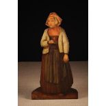 A Charming 19th Century Painted Pine Dummy Board, or Companion, of a peasant girl wearing a bonnet,