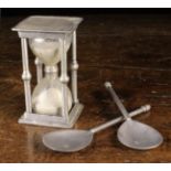 An Antique Pewter Egg Timer with glass twin chamber between square top & base decorated with