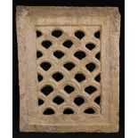 An 18th Century Pierced Limestone Grille carved with a symmetrical lunette repeat design,