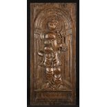 A 16th Century Arcaded Panel carved with depiction of Saint Clare carrying a monstrance,