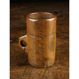 A 19th Century Dug Out Beechwood Measure with integral handle and ring turning.