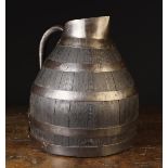 A Burgundian Coopered Oak Wine Jug bound in iron straps with an iron pouring lip,