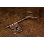 A Very Large 17th/Early 18th Century Iron Key with oval bow and 90 degree angled bit,