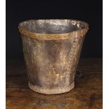 An 18th/Early 19th Century Leather Bucket with rivets afixing the side seams and circular foot,