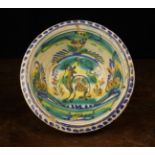 An 19th Century Maiolica Bowl decorated with manganese, veridian, ochre, yellow and blue glaze.