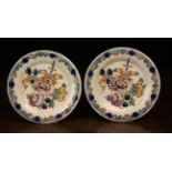 A Pair of Early 19th Century Polychromed Delft Plates decorated in manganese, orange, yellow,