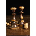 A Pair of 18th Century Turned Coramandel Candlesticks with knopped baluster stems and circular feet,