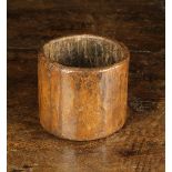 An 18th/19th Century Round Dug Out Treen Pot, 3½" (9 cm) high, 4" (10 cm) in diameter.