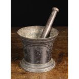 An 18th Century Cast Iron Pestle & Mortar, 5½" (14 cm) high, 6¼" (16 cm) in diameter.