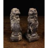 A Pair of 17th Century Carved Figural Finials in the form of Heraldic Lions Sejant.