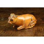 A Rare 19th Century Treen Snuff Box carved in the form of a Recumbent Cow with inset black bead