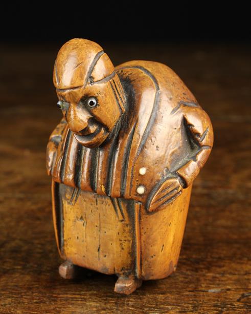 An Early 19th Century Carved Coquilla Nut Snuff Box in the form of grotesque hump backed man with