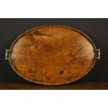 A Georgian Mahogany Bulter's Tray of oval form having a scalloped gallery and brass scroll handles