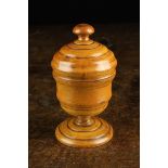 An Early 19th Century Turned Boxwood Spice Box standing on a pedestal foot,