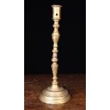 A Tall 18th Century Bronze Candlestick cast in three sections.