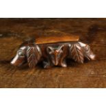 A 19th Century Fruitwood Snuff Box carved in the form of two hunting dog's heads separated on each