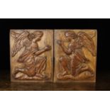 A Pair of 17th Century Franco Flemish Oak Panels carved in relief with kneeling winged angels,