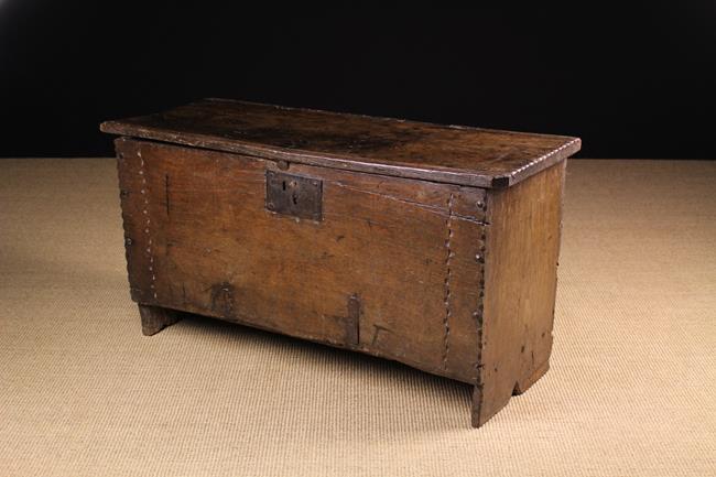 A Small 16th/Early 17th Century Boarded Oak Coffer composed of riven planks with chip carved ends.
