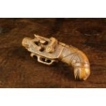 A Fabulous 19th Century Boxwood Snuff Box carved in the form of a Flintlock Pistol decorated with