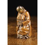 A Well Carved Early 19th Century Fruitwood Snuff Box in the form of a seated monk.