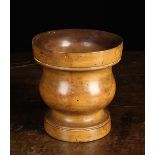 An 18th Century Turned Treen Mortar, possibly maple. 6¾" (17 cm) high, 6¼" (16 cm) in diameter.