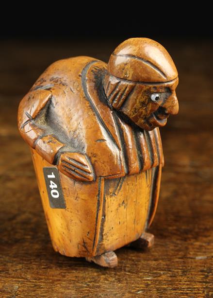 An Early 19th Century Carved Coquilla Nut Snuff Box in the form of grotesque hump backed man with - Image 2 of 3