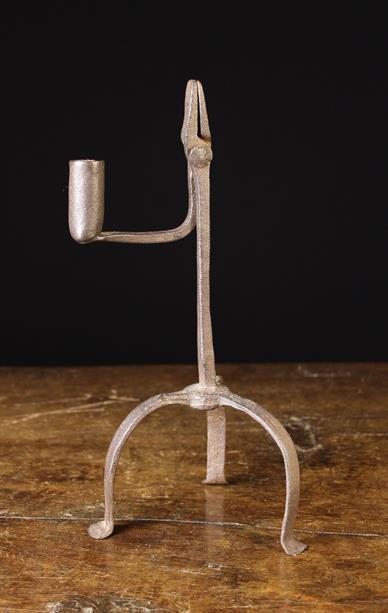 An Early 19th Century Wrought Iron Rushnip with counterweight arm bearing a rolled candle socket