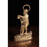 A 19th Century Brass Door Stop cast in the form of a man carrying a stick and drinking from an ale