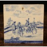 An 18th Century Dutch Blue & White Delft Tile painted with a winter landscape with skaters,