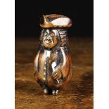 An 18th/19th Century Stained Walnut Snuff Box carved as a bewigged curmudgeonly gentleman with