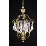 A Gilt Brass Hanging Hall Light in an etched clear glass tulip head enclosed by four scrolling arms