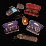 A Collection of Old Spectacles: Three with wire rims (one A/F), another with wire and horn rims,