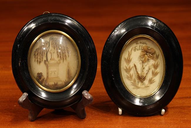 Two 19th Century French Hairwork Memorial Souvenirs set behind domed glass in moulded and ebonised