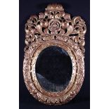 A 17th Century Baroque Style Carved Giltwood Mirror.