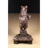 A Carved Black Forest Bear Stick Stand inset with amber glass and having a painted tongue,