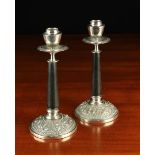 A Pair of Oriental White Metal and Black Composite Candlesticks.