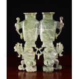 A Chinese Carved Green Onyx Conjoined Vase raised on rampant kylins, 8 (21 cm) high.