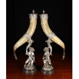 A Pair of Large Horn Snuff Mills with white metal mounts & figural stands.