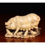 A Soapstone Carving of a Sow and Piglets, 6" (15 cm) in height, 9" (23 cm) in width.