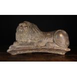An 18th Century Pine Relief Carving of a Recumbent Lion with flowing mane,