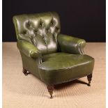 A Green Leather Upholstered Vintage Armchair with buttoned back,