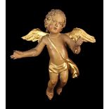 An 18th Century Polychromed Wood Carving of an Airborne Cherub.