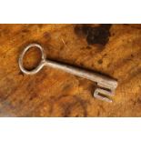 A Large 16th/17th Century Wrought Iron Key with a flared tubular wrapped iron shaft and oval bow,