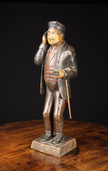 A 19th Century Polychromed Wood Carving of a Man wearing a beret, jacket, waistcoat and trousers,